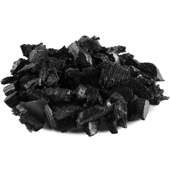 A pile of black, rough-textured solid rubber chunks arranged on a white background.
