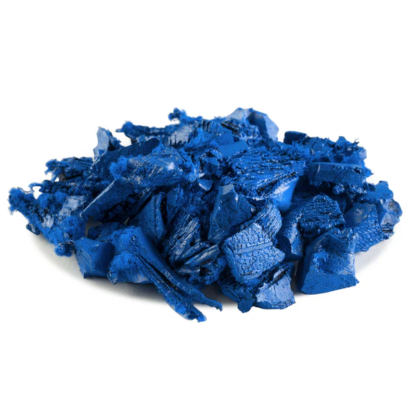 A pile of blue, rough-textured solid rubber chunks arranged on a white background.