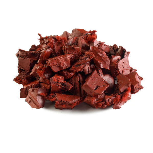 A pile of reddish-brown, rough-textured solid rubber chunks arranged on a white background.